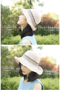 Détail d'un chapeau de paille rose avec ruban gris foncé et bordure ondulée