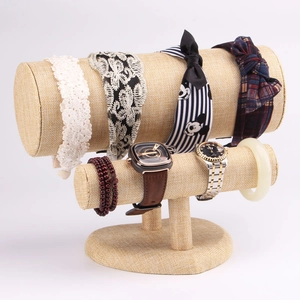Detail view of double-layer linen jewelry display stand for watches and bracelets