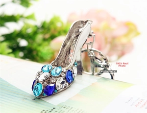 Close-up of sparkling rhinestone high heel keychain with blue and white gems
