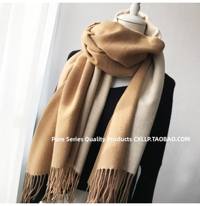 Detail of soft cashmere-like scarf with camel and beige two-tone splicing and fine tassels