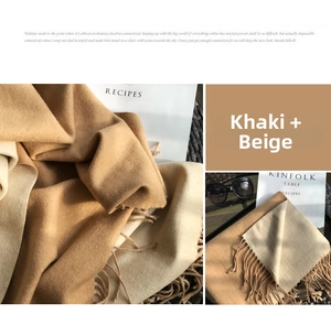 Detail of khaki and beige double-sided scarf showing soft texture and fine tassels