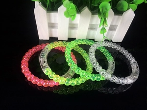 Detail view of colorful LED light-up acrylic bracelets in pink, yellow, and green