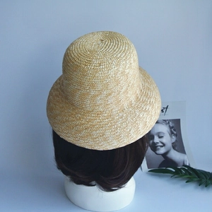 Detailed view of handmade woven texture on a natural straw cloche hat for sun protection