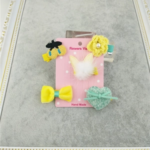 Handmade 5-piece girls hair clips set with fur crown, cherry, and bow motifs on display card