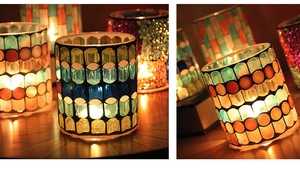Close-up of mosaic glass candle holders in blue-green and red-orange patterns