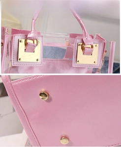 Detailed shot of pink transparent PVC tote bag with gold buckle and bottom protective studs
