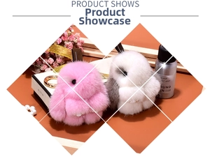 Detail showing two plush bunny pendants in pink and grey-white with metal keyrings
