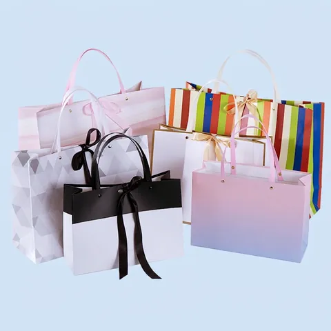 Paper Gift Bags Handheld Tote Bags Cardboard Laminated Rivet Reinforced Bow Ribbon Handle Shopping Party Packaging Elegant