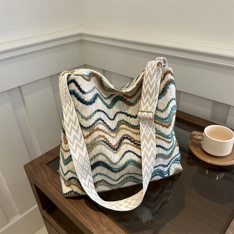 Large Capacity Knit Bucket Bag Women Slouchy Woven Wave Pattern Shoulder Bag With Wide Geometric Strap And Plush Pendant
