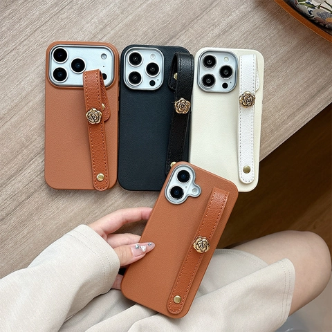 Lychee Grain Leather Phone Case With Metal Camellia Flower Wristband Hand Strap Soft TPU Shockproof Shell For Women