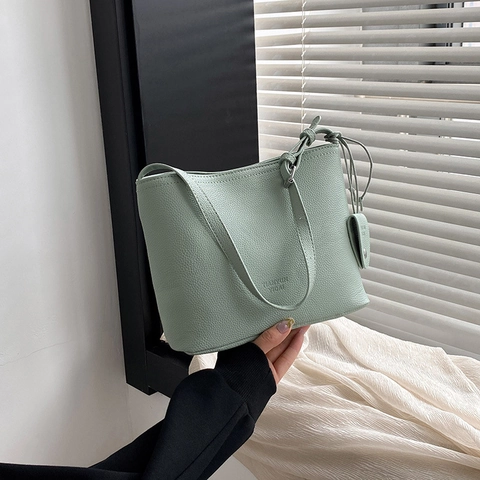 Women Minimalist Litchi Grain PU Leather Bucket Bag Adjustable Shoulder Strap Magnetic Closure Crossbody Bag With Hanging Ornament