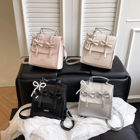 Moda Zaino Mini da Donna in Pelle PU Con Fiocco Borsa a Mano Trasformabile Borsa a Tracolla Zaino Street Style Con Ciondolo Perla