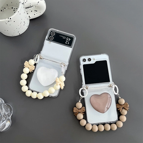 Transparent Folding Smartphone Case With 3D Heart Airbag Stand And Bow Bead Hand Chain Strap Shockproof Ins Style
