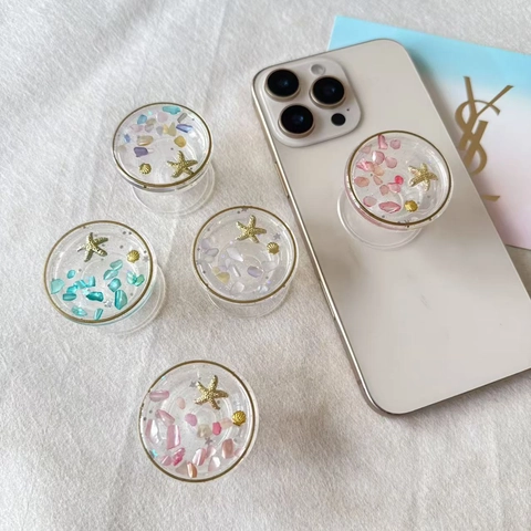 Soporte Expandible Para Teléfono Resina Transparente Tema Oceánico Con Estrella De Mar Dorada Y Decoraciones De Concha