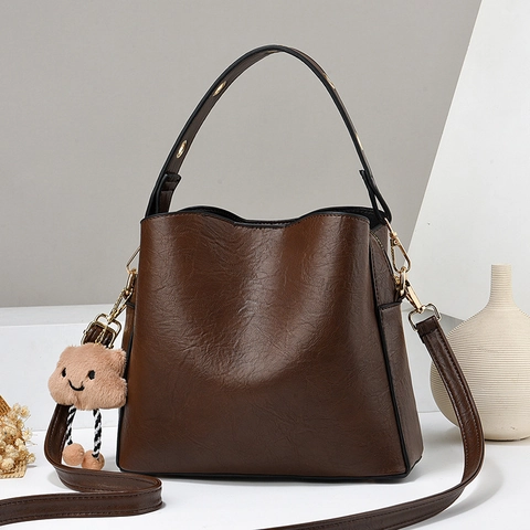 Textured PU Leather Bucket Bag Handheld Shoulder Crossbody Bag For Women Modern Daily Use Handbag With Plush Charm