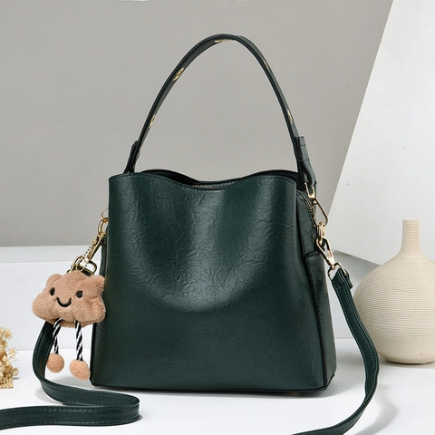 Textured PU Leather Bucket Bag Handheld Shoulder Crossbody Bag For Women Modern Daily Use Handbag With Plush Charm