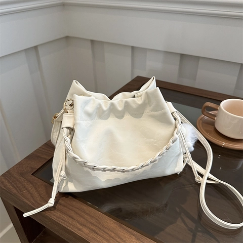 Sac Seau Bandoulière Femme Cuir PU Plissé Poignée Tressée Cordon De Serrage Avec Breloque En Peluche Élégant