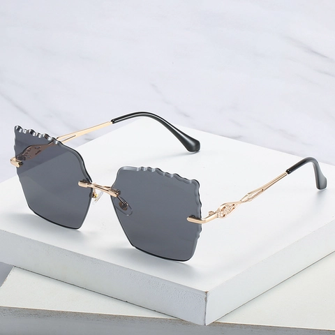 Lunettes De Soleil Sans Monture Femmes Cadre Métal Bords Ondulés Verres Dégradés PC Protection UV400 Mode