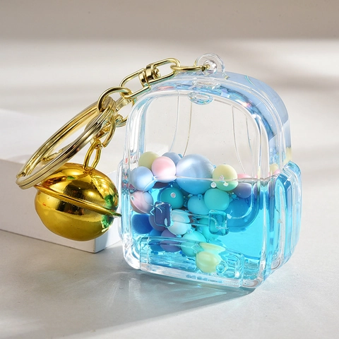 Mignon Porte-clés de Sac d'école en Acrylique Avec Bonbons Colorés Sable Mouvant Liquide Pendentif Cloche Dorée pour Filles