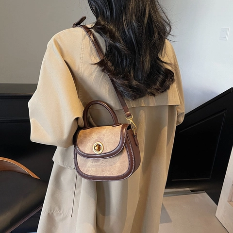 Retro PU Leather Saddle Crossbody Bag For Women Vintage Patchwork Shoulder Bag With Metal Rotary Lock Top Handle Handbag
