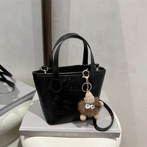 Women Crossbody Bucket Bag PU Leather Embossed Handbag With Plush Monster Charm Removable Strap Urban Minimalist