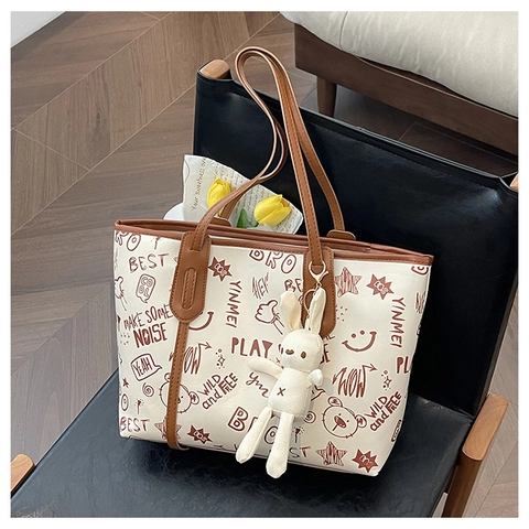 Women's Graffiti Letter Print PU Leather Tote Bag Large Capacity Urban Casual Shoulder Bag With Cute Bunny Charm Daily Bag