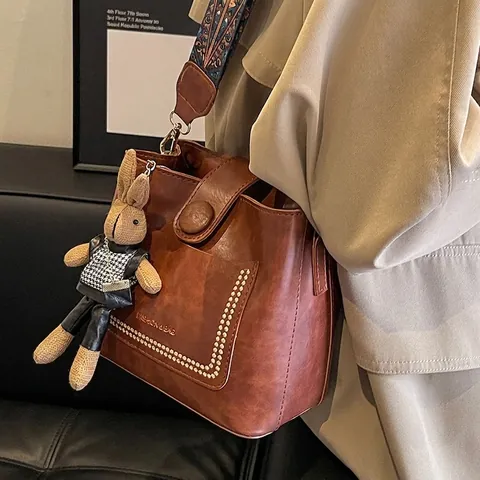 Women Vintage PU Leather Bucket Bag With Ethnic Wide Strap Rivet Decor Retro Shoulder Crossbody Bag With Rabbit Pendant