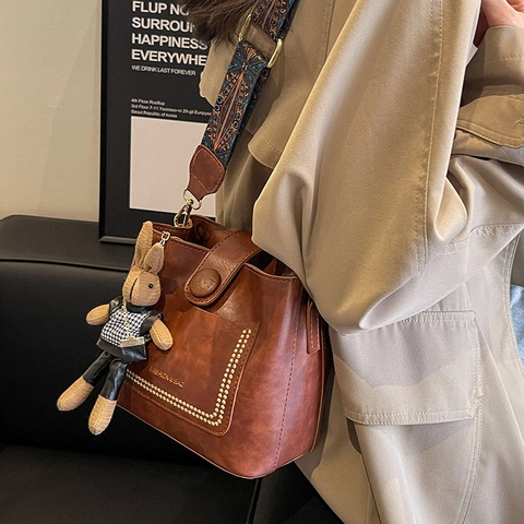 Women Vintage PU Leather Bucket Bag With Ethnic Wide Strap Rivet Decor Retro Shoulder Crossbody Bag With Rabbit Pendant