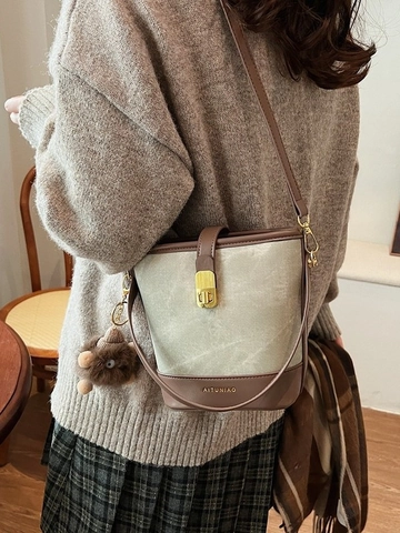 Women Vintage Canvas PU Leather Bucket Bag Contrast Color Shoulder Crossbody Bag With Metal Lock And Monster Pendant