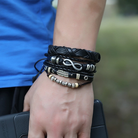 Bracciale in Pelle di Vacchetta Intrecciata Vintage Multistrato Gioielli Bohemian Punk Con Ciondolo Piuma Infinito Uomo Donna
