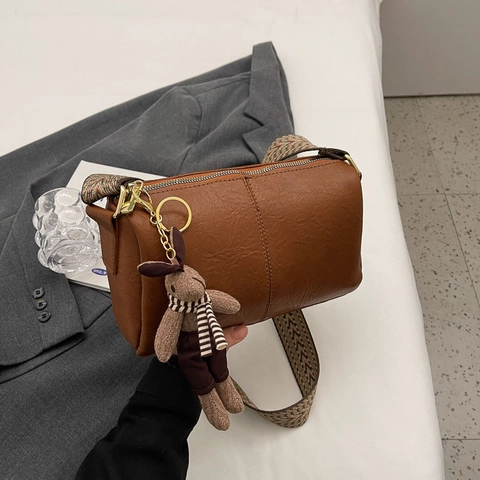Women Vintage PU Leather Pillow Crossbody Bag Wide Jacquard Strap Small Boston Shoulder Bag With Plush Rabbit Pendant