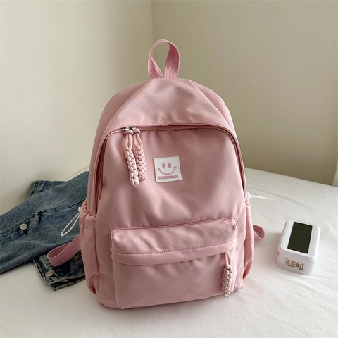 Sac à Dos Minimaliste en Tissu Oxford pour Femmes Étudiants Simple Couleur Unie Décontracté Cartable Avec Visage Souriant Style Japonais Ins Sac de Voyage