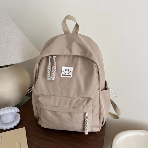 Sac à Dos Minimaliste en Tissu Oxford pour Femmes Étudiants Simple Couleur Unie Décontracté Cartable Avec Visage Souriant Style Japonais Ins Sac de Voyage