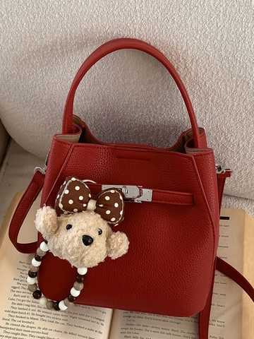 Damen Koreanischer Einfacher PU Leder Eimer Tasche Litschi Muster Metall Drehverschluss Schulter Umhängetasche Mit Bärenanhänger Handtasche