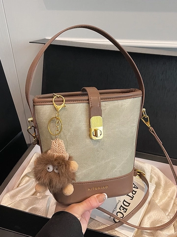 Women's PU Leather Color-Blocked Bucket Bag With Gold Lock And Furry Monster Charm Stylish Urban Crossbody Shoulder Bag