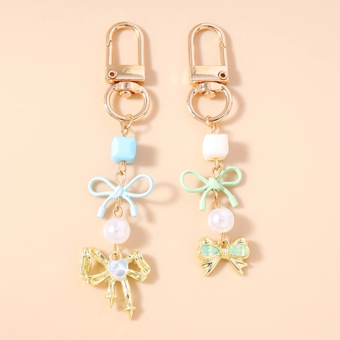 Elegante Portachiavi con Fiocco in Lega e Künstliche Perle Dolce Ciondolo per Borsa Charm Nastro a Cuore Fiocco Portachiavi Regalo Donna