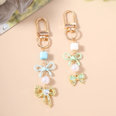 Elegante Portachiavi con Fiocco in Lega e Künstliche Perle Dolce Ciondolo per Borsa Charm Nastro a Cuore Fiocco Portachiavi Regalo Donna