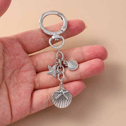 Llavero de Metal Plateado Vintage con Estrella de Mar y Concha Colgante de Bolso Tema Océano Hebilla de Estrella Verano Playa