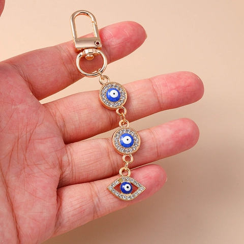 Modischer Gold Galvanisierter Zinklegierung Böser Blick Schlüsselanhänger Mit Seestern Hand Der Fatima Strass Emaille Taschenanhänger