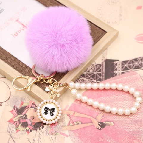 Porte-clés de Luxe en Alliage avec Boule de Fourrure Synthétique et Chaîne de Perles Artificielles Nœud Pendentif Élégant Décoration de Sac à Main