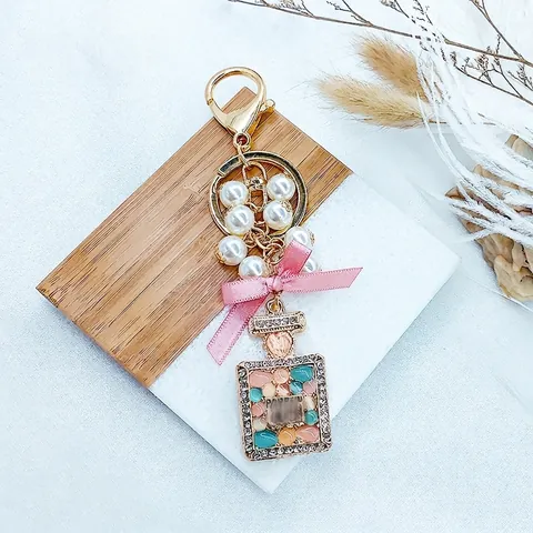 Elegant Perfume Bottle Keychain Pink Satin Ribbon Bow Artificial Pearl Alloy Rhinestone Inlaid Bag Charm Jewelry Gift For Women