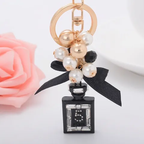 Elegante Llavero de Frasco de Perfume de Aleación de Zinc Con Lazo de Satén Perla Artificial Incrustación de Strass Colgante de Bolso Moda Regalo Mujer