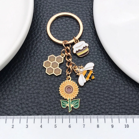 Portachiavi ape con vasetto di miele e alveare di girasole in lega smaltata placcata oro con ciondoli multipli e perla artificiale per accessori borsa donna regalo