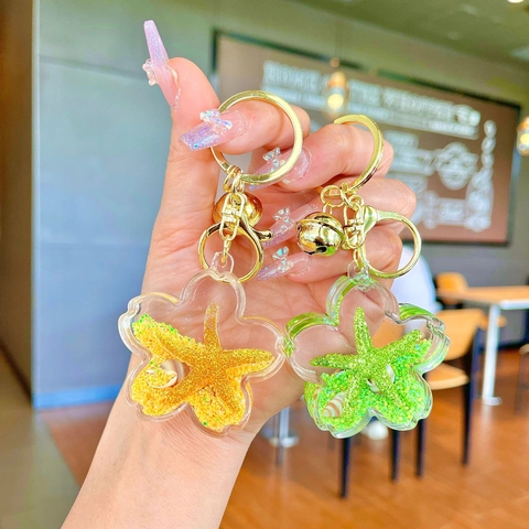 Llavero de Acrílico con Flor y Estrella de Mar Arena Movediza con Campana Concha Piruleta Colgante de Bolso Estilo Marino Regalo para Mujer Niña