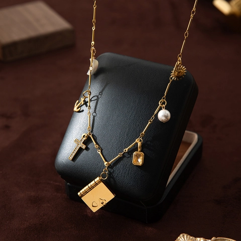 Collana Vintage in Acciaio Inossidabile Placcato Oro 18K con Ciondoli Multipli Sole Perla Artificial Croce Libro Ancora Luna Donna