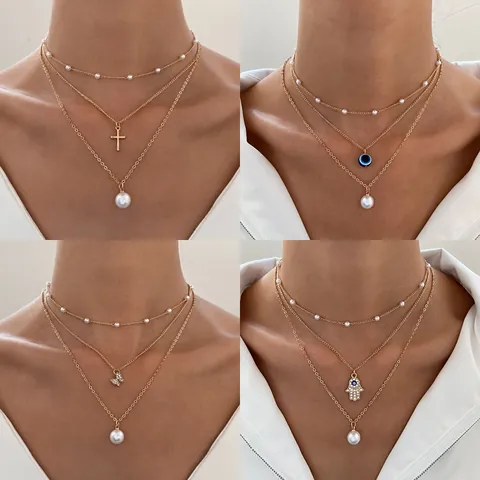 Collier Multirang en Alliage et Künstliche Perles Synthétiques avec Pendentif Mauvais Œil Main de Fatma Papillon Croix pour Femme Bijoux Mode