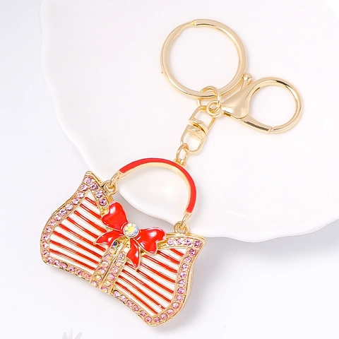 Portachiavi a Forma di Borsa di Lusso in Lega di Zinco Placcato Oro Con Strass Fiocco Pendente a Strisce Ornamento per Borsa Donna