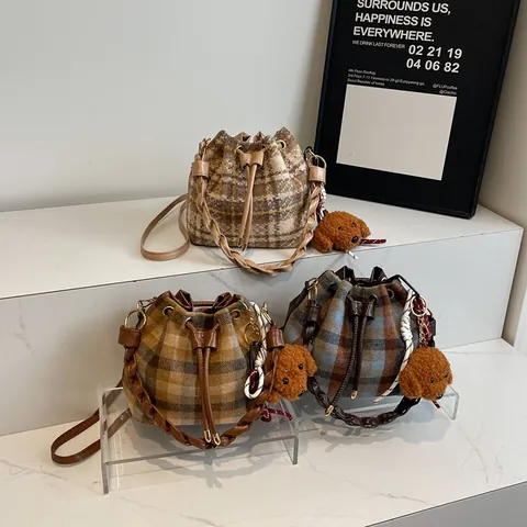 Vintage Plaid Woolen Bucket Bag For Women Retro Drawstring Crossbody Shoulder Bag With Woven Handle And Plush Pendant