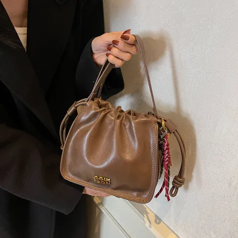 Women's Retro PU Leather Bucket Bag Drawstring Pleated Shoulder Bag Casual Crossbody Bag With Braided Rope Charm