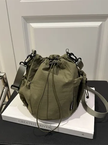 Women's Nylon Drawstring Bucket Bag Outdoor Sporty Casual Crossbody Bag With Adjustable Strap And Side Mesh Pocket